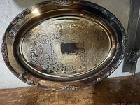 Full view of oval electroplated brass serving tray showing overall design and engraving