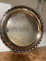 Full view of round silver-plated tray showing overall design and wear
