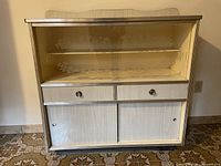 Full frontal view of cabinet showing drawers, glass display area, and lower sliding doors
