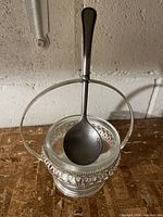 full view of jam dish with handle up and spoon inside
