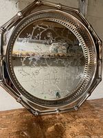 Full view of silver-plated round tray showing floral engraving and octagonal bamboo-style rim