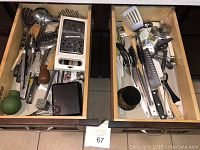 Top-down view of two kitchen drawers with assorted utensils including graters, spatulas, tongs, knives, whisks