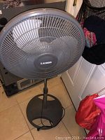 Lasko floor fan front view showing grille, blades, and base