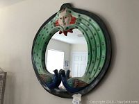 Front view of the large peacock mirror showing the two peacocks, sun motif, and circular mirror in the center.