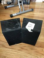 Two speakers front cabinet view without grills, showing black wood veneer finish