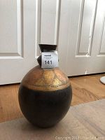 Front view of the decorative home decor jug showing the dark brown body with golden mosaic pattern on top and the square flared rim neck