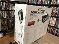 Box of Numark TTUSB turntable showing front, side, and specifications with emphasis on USB audio recording capability.