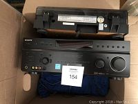 Front view of Sony digital audio/video control center with remote control unit on top.