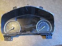 Front view of Cadillac CT6 speedometer cluster showing gauges and lens