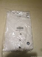 Front view of packaged white Hollister Henley shirt