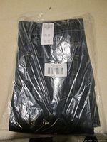 Jeans folded in sealed plastic bag with visible top stitching