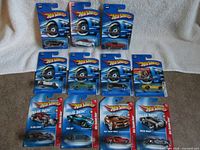 All 11 carded Hot Wheels cars laid out