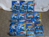 Group shot of 11 sealed Hot Wheels motorcycle cards