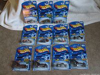All eleven Hot Wheels motorcycle cards arranged for count verification