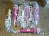 Four pink I ♥ SPK microphones in bubble wrap