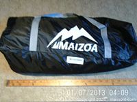 Maizoa branded black carry bag containing tent components