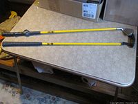 Full view of both Momentus swing trainer clubs on table