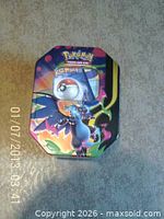 Closed Pokemon collector tin with Charizard artwork