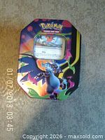 Closed Pokemon collector tin with Charizard artwork