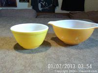 Both Pyrex bowls side by side showing size comparison and colors