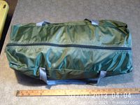 Zippered green carry bag with ruler for scale