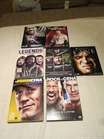All seven WWE DVD cases laid out