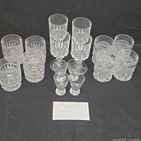 Group shot of all 16 clear pressed glass pieces