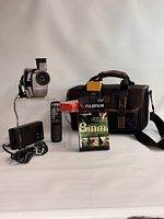 Group shot of camcorder, charger, remote, tapes, batteries, bag