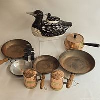 Group shot showing all cookware, shakers, ceramic loon jar and stone inukshuk