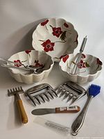 Full lot showing three floral bowls, utensils and meat claws