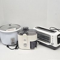 Front view of rice cooker, juicer and toaster oven side by side