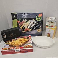 Group shot of all boxed sets and ceramic dish