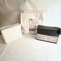 All three sealed packages: Sunbeam heated mattress pad, white Egyptian Comfort sheet set, black Egyptian Comfort sheet set