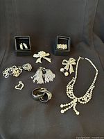 Overview of entire vintage costume jewelry collection on black backdrop
