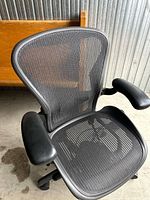 Front angled view showing mesh seat, backrest, and armrests