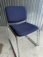 Front-side view of navy fabric sled-base chair with chrome frame
