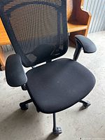 Front view showing mesh back, seat, armrests, base