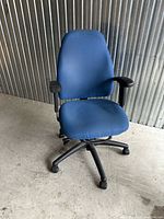 Front view of blue office chair showing upholstery and base