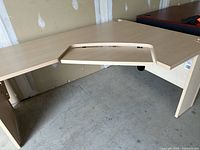 Full view of L-shaped desk showing overall structure and curved cut-out