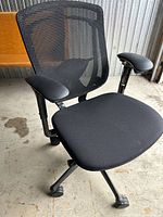 Front angled view showing mesh back, seat cushion, armrests and X-base with casters