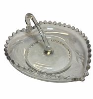 Top view of clear heart-shaped dish showing handle and beaded rim