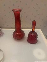 vase and bell side by side showing overall form and colour