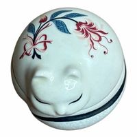 Top view of porcelain cat trinket box showing floral motif
