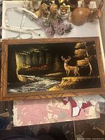 Full view of framed velvet painting with deer scene