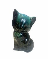 Front view of glazed cat figurine showing colors and pose