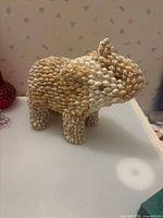 Full view of seashell animal figurine standing on four legs