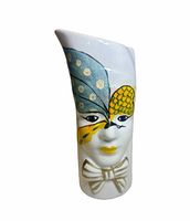 Front view showing masked face design and bow tie