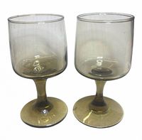 Front view of both olive green glass goblets showing overall design