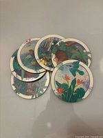 Top view of stacked illustrated coasters