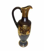 Full view of pitcher vase showing handle, spout and gold floral band